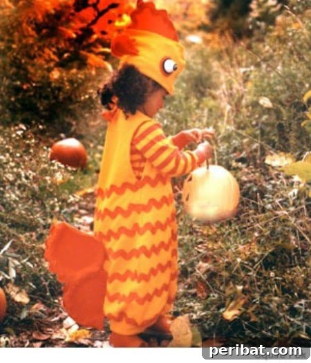 75 Effortless DIY Halloween Costumes That Kids Adore 68 A child in a beautiful 'Gold Fish' costume for Halloween, featuring fins made from fabric-covered paper plates, ribbon stripes, and a ping pong ball eyeball, a creative no-sew DIY idea