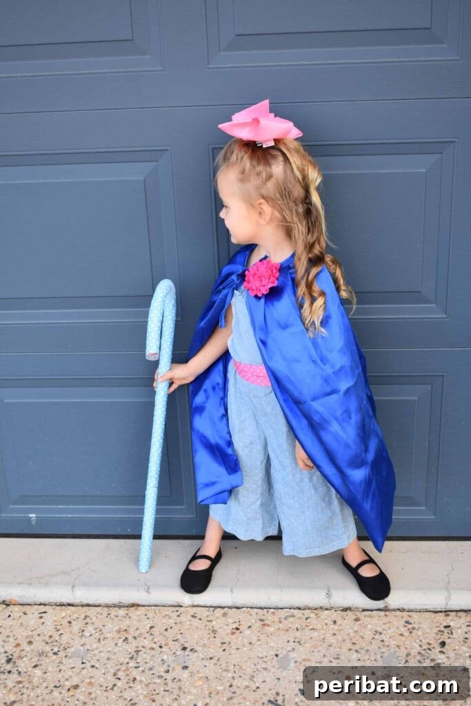 75 Effortless DIY Halloween Costumes That Kids Adore 8 A young girl in a DIY Toy Story Bo Peep costume, standing confidently by a garage door