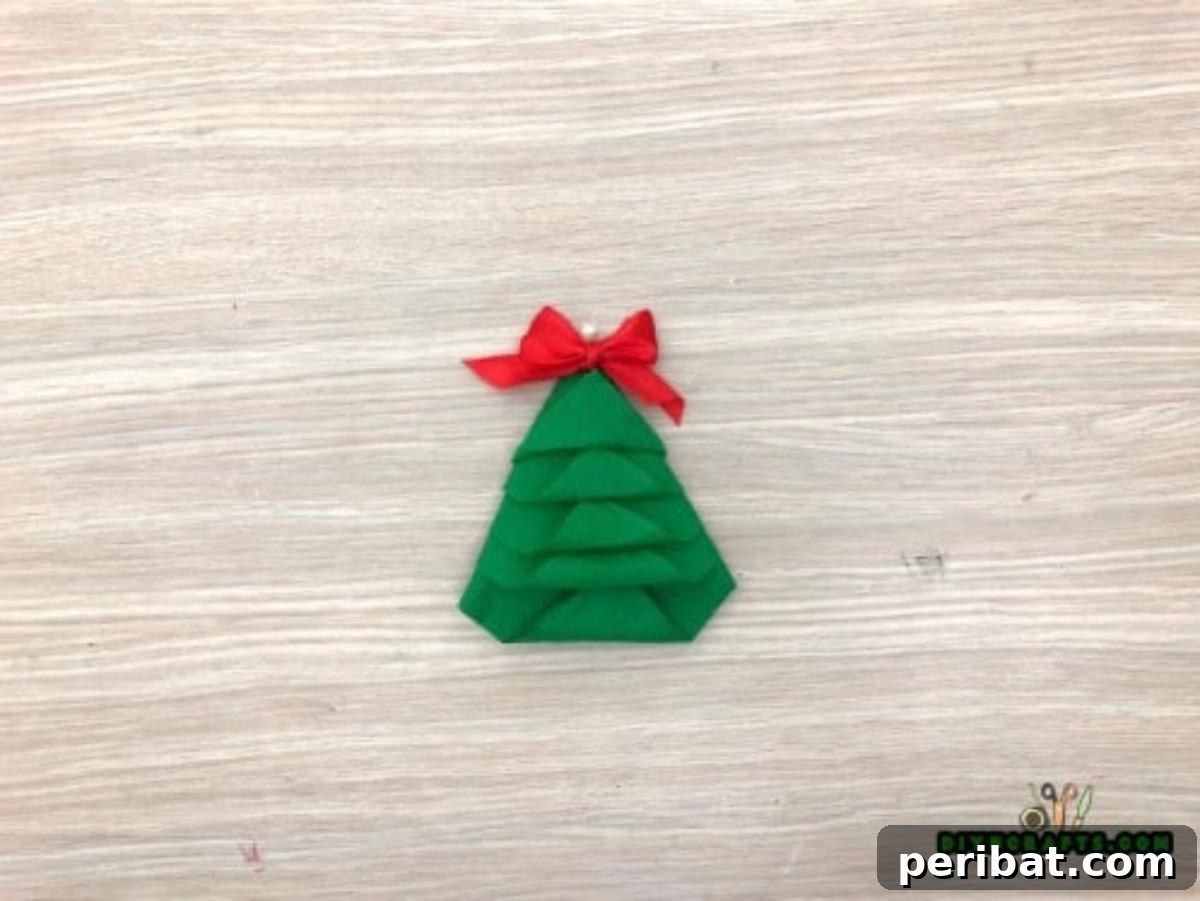 5 DIY Christmas Napkin Designs: Festive Folds, Easy Video How-To 15 Tree Napkin - Completed amazing paper napkin Christmas tree, ideal for elegant Christmas table decor.