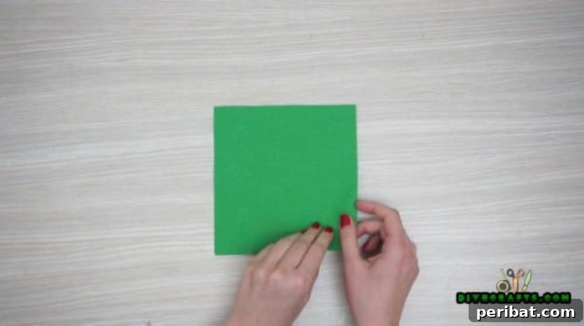 5 DIY Christmas Napkin Designs: Festive Folds, Easy Video How-To 16 Fancy Napkin - Begin with a green square, fold in half both ways for guide lines for elegant napkin fold.