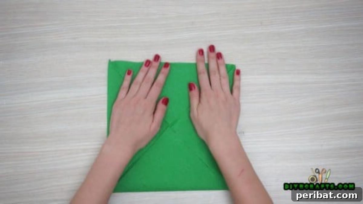 5 DIY Christmas Napkin Designs: Festive Folds, Easy Video How-To 19 Fancy Napkin - Repeat folding corners for an intricate, beautiful napkin arrangement.
