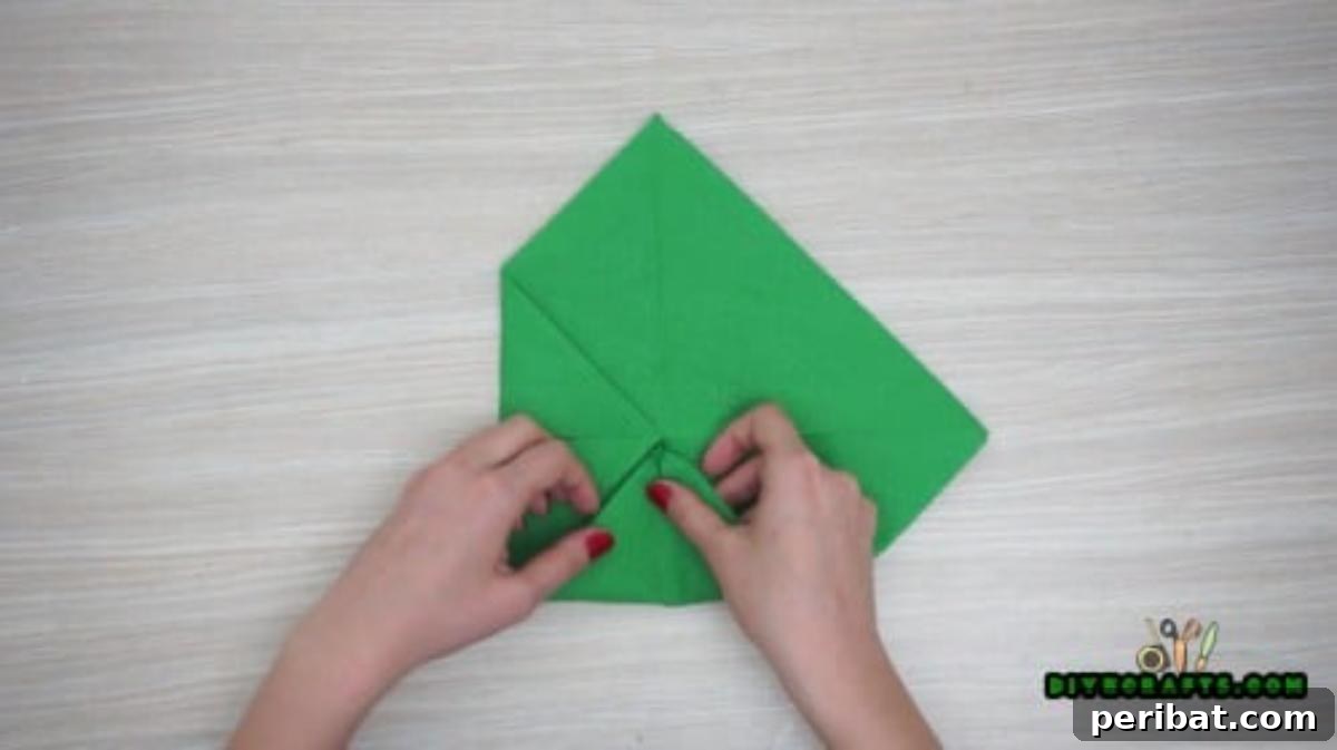 5 DIY Christmas Napkin Designs: Festive Folds, Easy Video How-To 20 Fancy Napkin - Turn over, fold corners to center again for elegant multi-layered napkin fold.