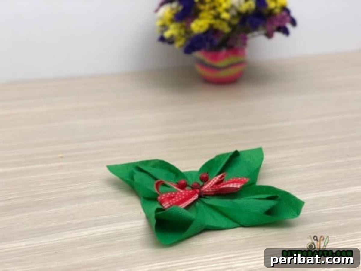 5 DIY Christmas Napkin Designs: Festive Folds, Easy Video How-To 24 Fancy Napkin - Embellish the center for a festive finish, your elegant Christmas napkin is complete!