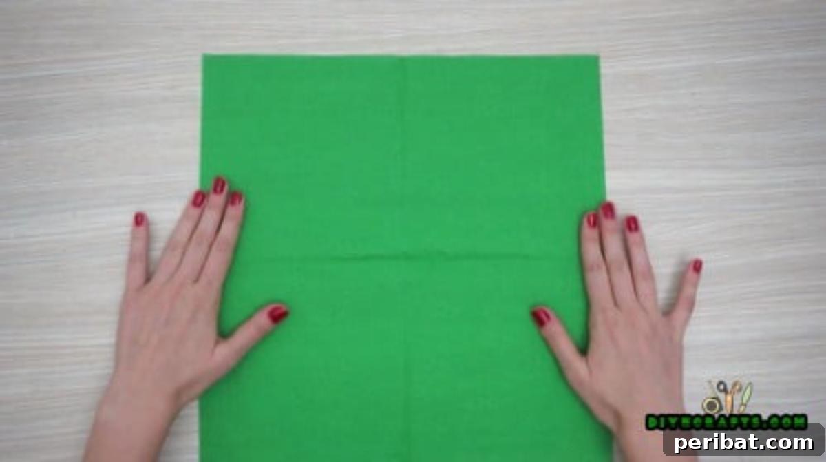 5 DIY Christmas Napkin Designs: Festive Folds, Easy Video How-To 25 Elf Boot Napkins - Start with a green square, fold in half both directions for guide lines, festive craft.