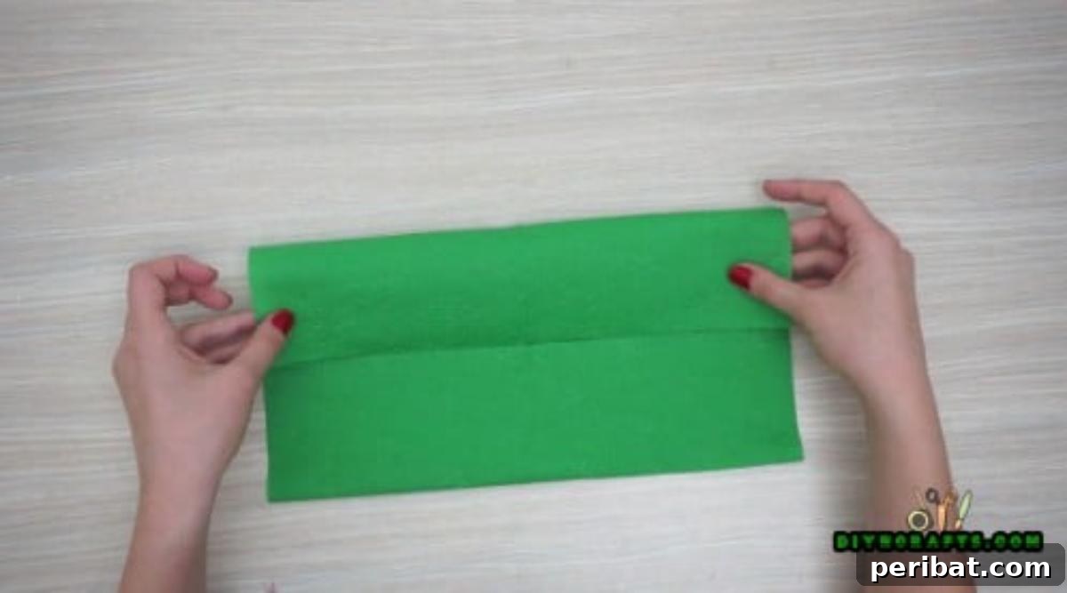5 DIY Christmas Napkin Designs: Festive Folds, Easy Video How-To 26 Elf Boot Napkins - Fold top and bottom edges to center, then fold lengthwise for elf boot base.