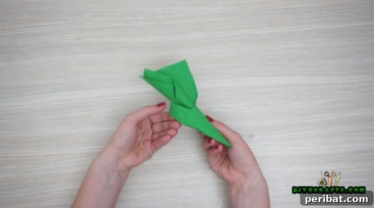 5 DIY Christmas Napkin Designs: Festive Folds, Easy Video How-To 30 Elf Boot Napkins - Invert open end to form boot cuff, completing your charming Christmas elf boot.