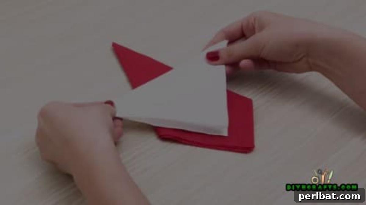 5 DIY Christmas Napkin Designs: Festive Folds, Easy Video How-To 4 Santa Napkin - Fold white napkin into a triangle for Santa's beard, easy DIY Christmas craft.