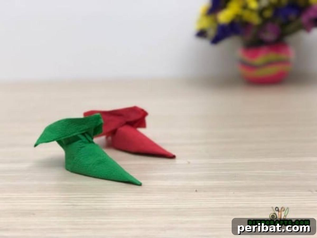 5 DIY Christmas Napkin Designs: Festive Folds, Easy Video How-To 31 Elf Boot Napkins - Finished cute pair of paper elf boots, perfect whimsical Christmas table decor.