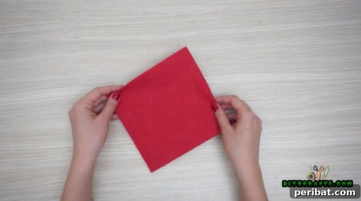 5 DIY Christmas Napkin Designs: Festive Folds, Easy Video How-To 32 Christmas Hat Napkin - Fold red square napkin twice to form smaller square, easy Christmas DIY.
