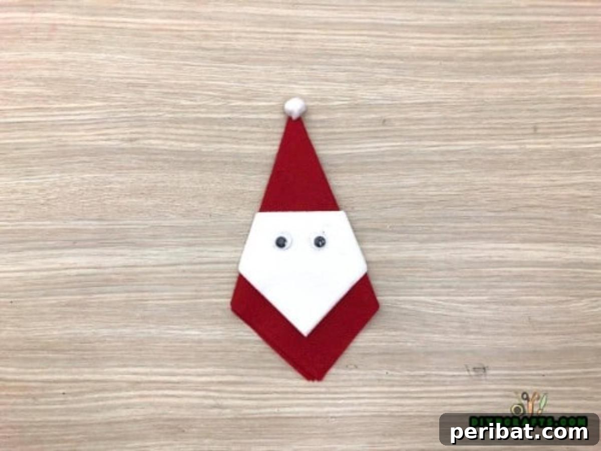 5 DIY Christmas Napkin Designs: Festive Folds, Easy Video How-To 8 Santa Napkin - Your finished adorable Santa napkin, a must-have for Christmas table decor.