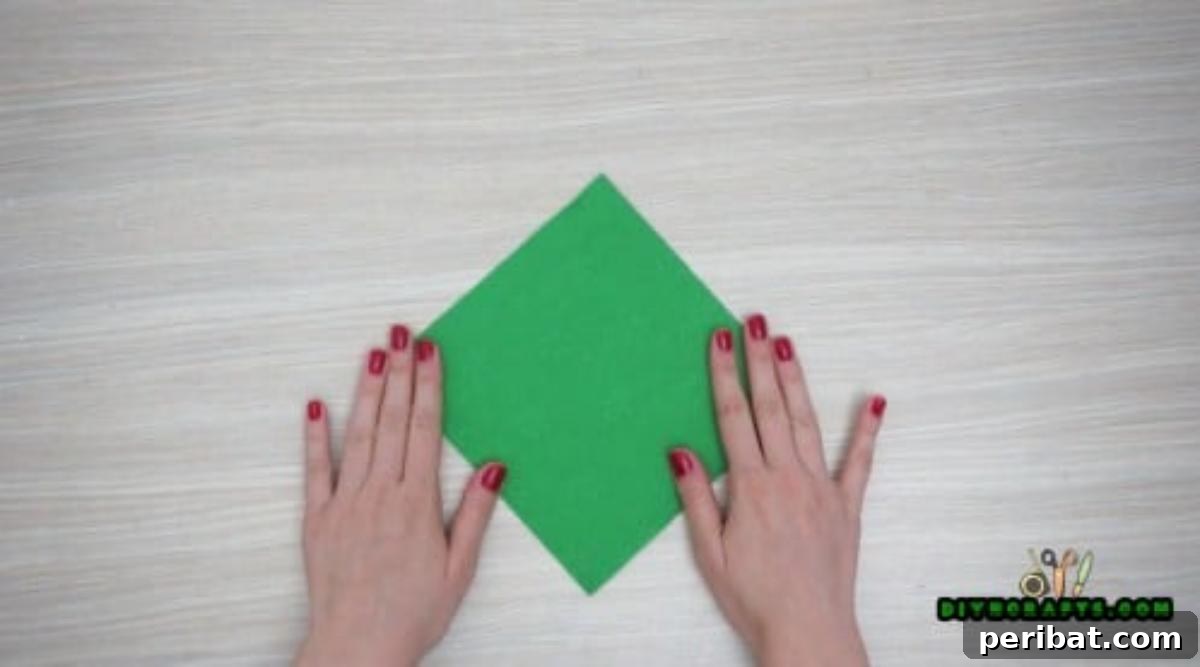 5 DIY Christmas Napkin Designs: Festive Folds, Easy Video How-To 9 Tree Napkin - Stack green napkins for a layered Christmas tree fold, essential for festive decor.