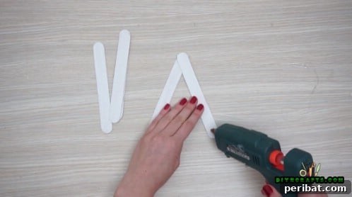 Effortless Holiday Crafting 5 DIY Ornament Videos 15 Continuing to build the star shape with craft sticks