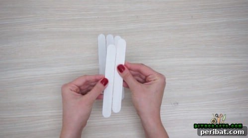 Effortless Holiday Crafting 5 DIY Ornament Videos 4 Gather five craft sticks for sleigh ornament