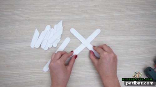 Effortless Holiday Crafting 5 DIY Ornament Videos 32 Glue three complete craft sticks together for the snowflake base
