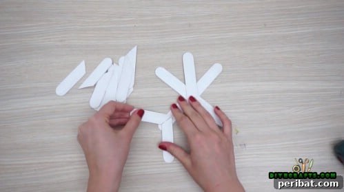 Effortless Holiday Crafting 5 DIY Ornament Videos 34 Attach diagonally cut craft stick pieces to the snowflake arms