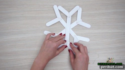 Effortless Holiday Crafting 5 DIY Ornament Videos 35 Detailed view of adding small craft stick segments to the snowflake