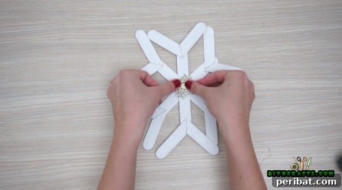 Effortless Holiday Crafting 5 DIY Ornament Videos 36 Embellish the craft stick snowflake with glitter or gems