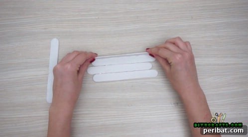 Effortless Holiday Crafting 5 DIY Ornament Videos 7 Glue two craft sticks perpendicularly to form sleigh sides