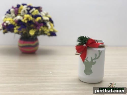 Completed DIY Upcycled Mason Jar Reindeer Tea Light Holder glowing softly