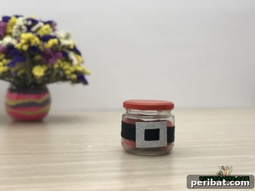 Decorative Santa Belt Candy Jar filled with red-wrapped candies