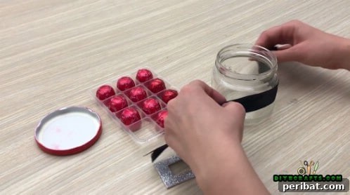 5 Frugal & Festive Christmas Jar Decorations 18 Step 2: Wrap a black ribbon around the jar, securing it with hot glue to create Santa's belt.