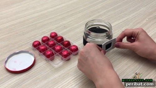 5 Frugal & Festive Christmas Jar Decorations 19 Step 3: Attach a square-shaped metallic or glittery buckle frame onto the center of the black ribbon.