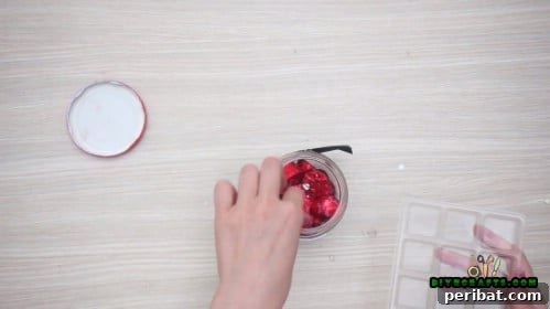 5 Frugal & Festive Christmas Jar Decorations 20 Step 4: Fill the Santa jar with red-wrapped candies or chocolates.