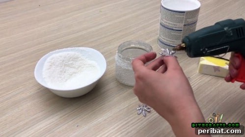 5 Frugal & Festive Christmas Jar Decorations 36 Step 4: Use a hot glue gun to attach snowflake embellishments to the snow-covered jar.