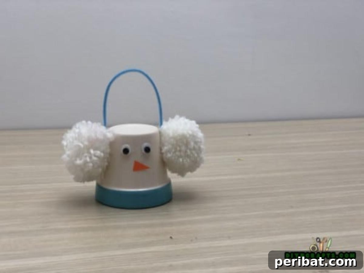 Minute-Made Snowmen: 5 Speedy & Creative Crafts 16 Completed cup snowman made from two plastic cups, with button eyes, an orange nose, and straw hair