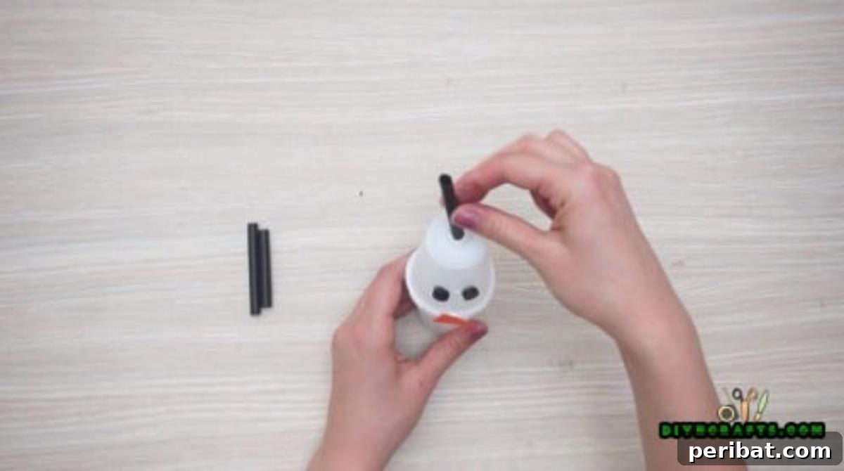Minute-Made Snowmen: 5 Speedy & Creative Crafts 22 Close-up of the cup snowman with both button eyes firmly attached