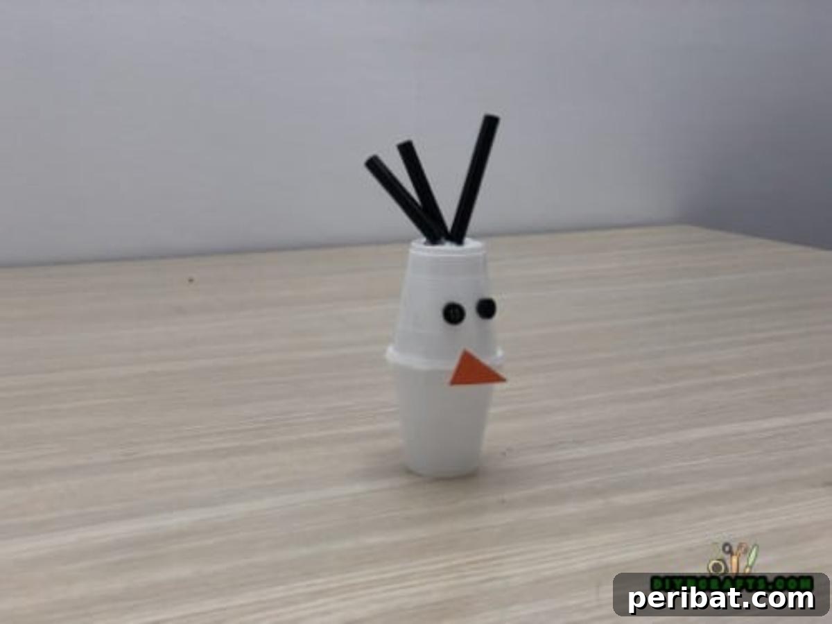 Minute-Made Snowmen: 5 Speedy & Creative Crafts 23 Final details being added to the cup snowman, with small pieces of straw glued to the top