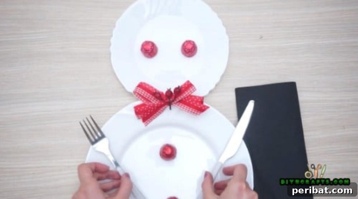 Minute-Made Snowmen: 5 Speedy & Creative Crafts 27 A nearly complete snowman plate place setting with cutlery and a napkin alongside