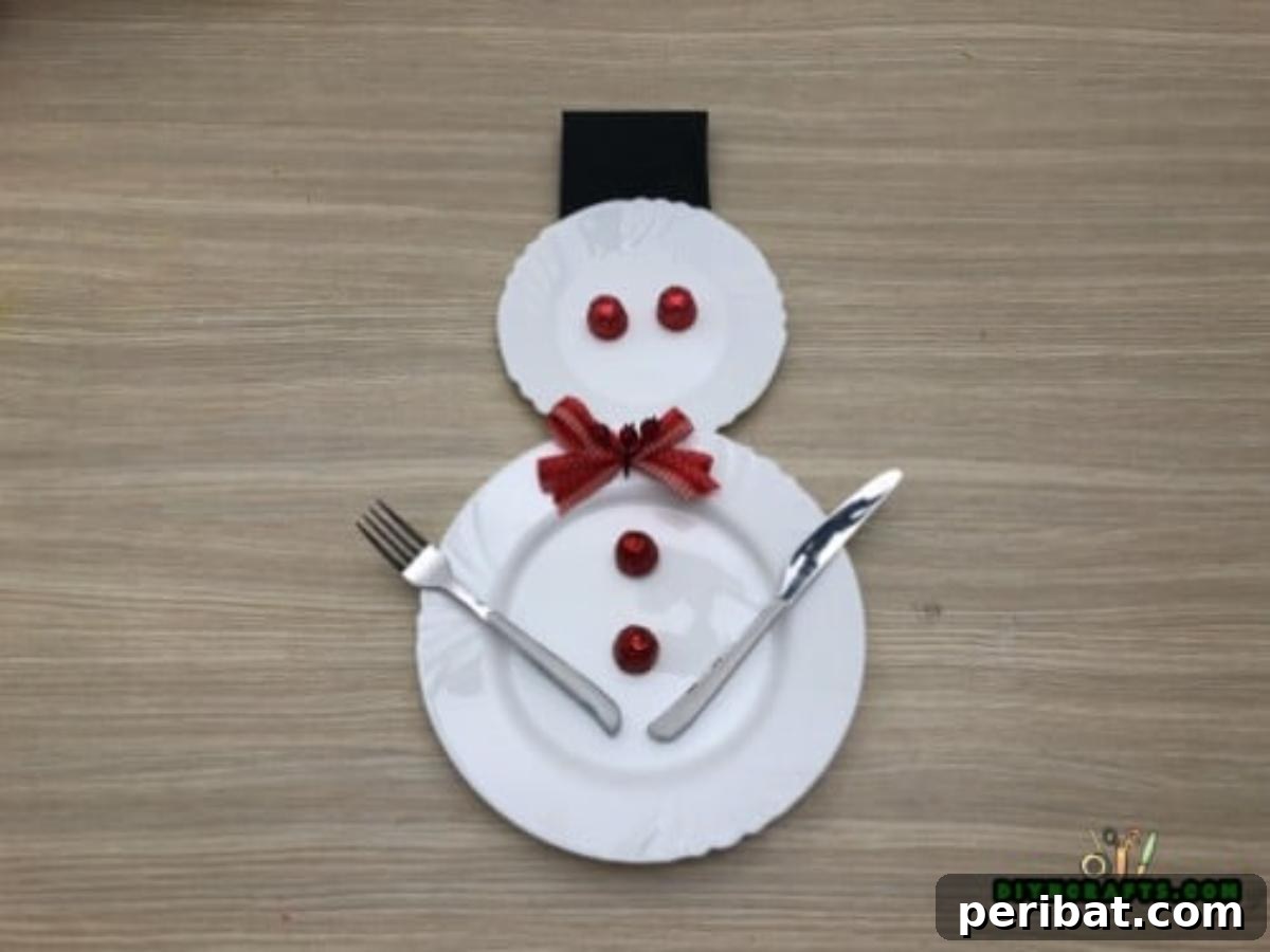 Minute-Made Snowmen: 5 Speedy & Creative Crafts 28 A fully set holiday table place setting, featuring a snowman made from two plates, candy, cutlery, and a napkin