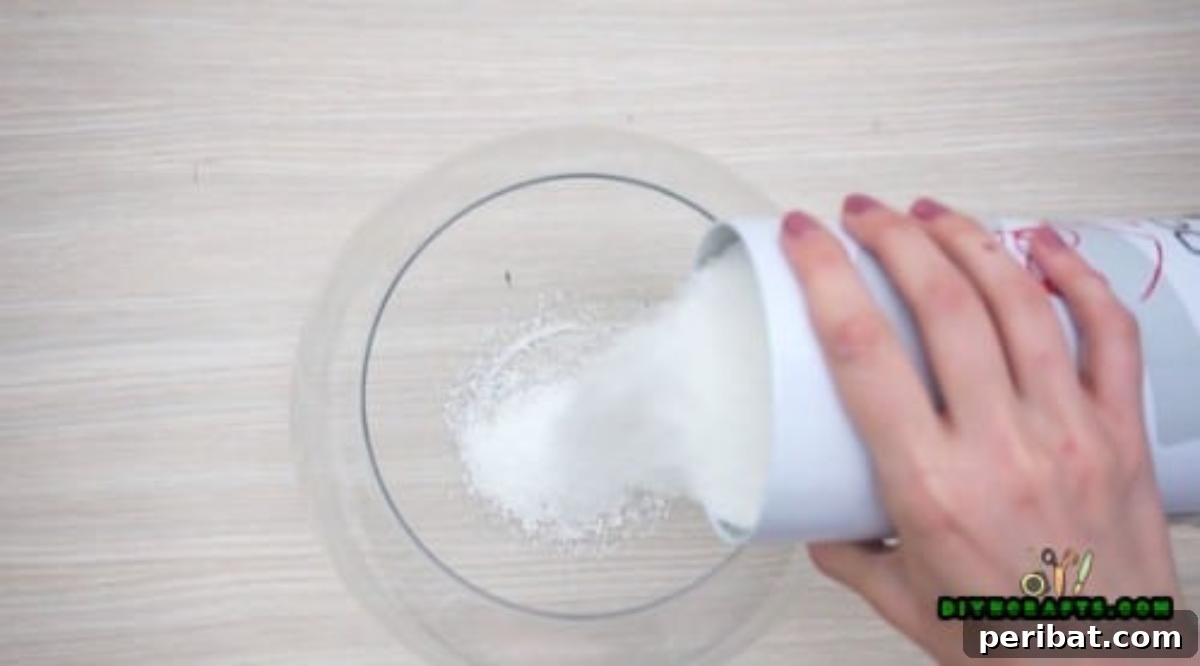 Minute-Made Snowmen: 5 Speedy & Creative Crafts 29 Pouring craft snow into a large glass fishbowl for a DIY snowman centerpiece