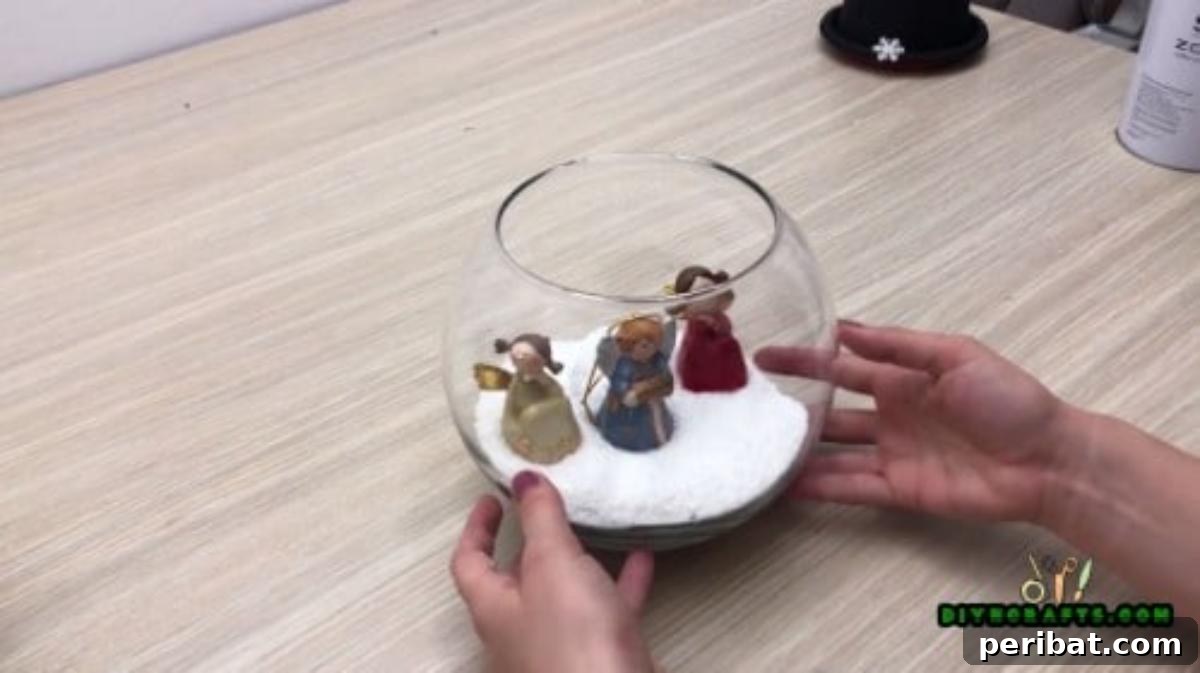 Minute-Made Snowmen: 5 Speedy & Creative Crafts 34 Smaller fishbowl carefully stacked on top of a larger fishbowl, forming a two-tier snowman structure
