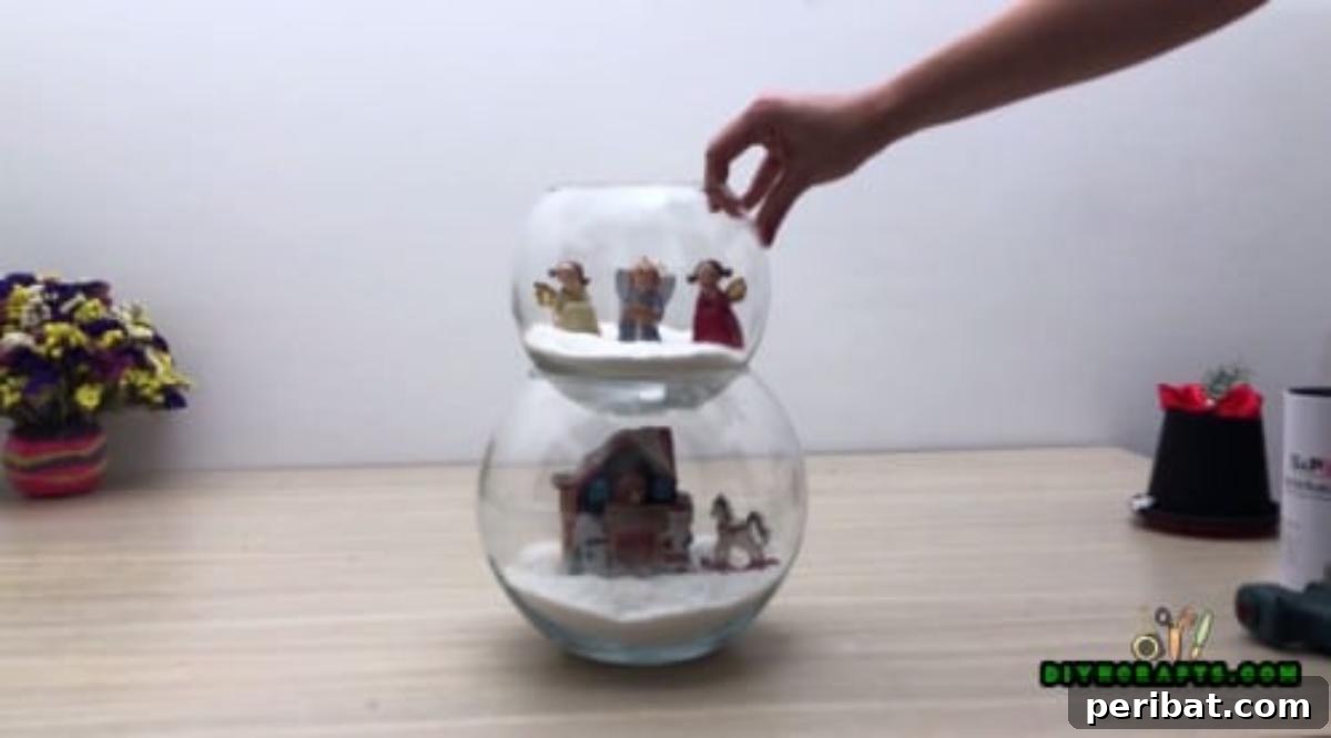 Minute-Made Snowmen: 5 Speedy & Creative Crafts 35 Placing a small decorative hat on top of the stacked fishbowls to complete the snowman centerpiece