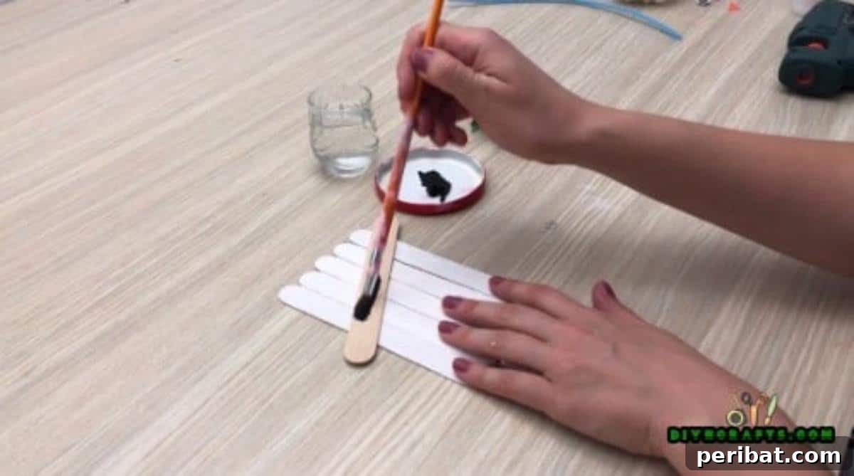 Minute-Made Snowmen: 5 Speedy & Creative Crafts 5 Craft stick snowman with its hat section painted black