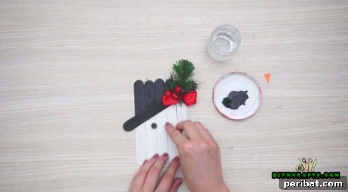 Minute-Made Snowmen: 5 Speedy & Creative Crafts 8 Craft stick snowman with two button eyes successfully glued in place