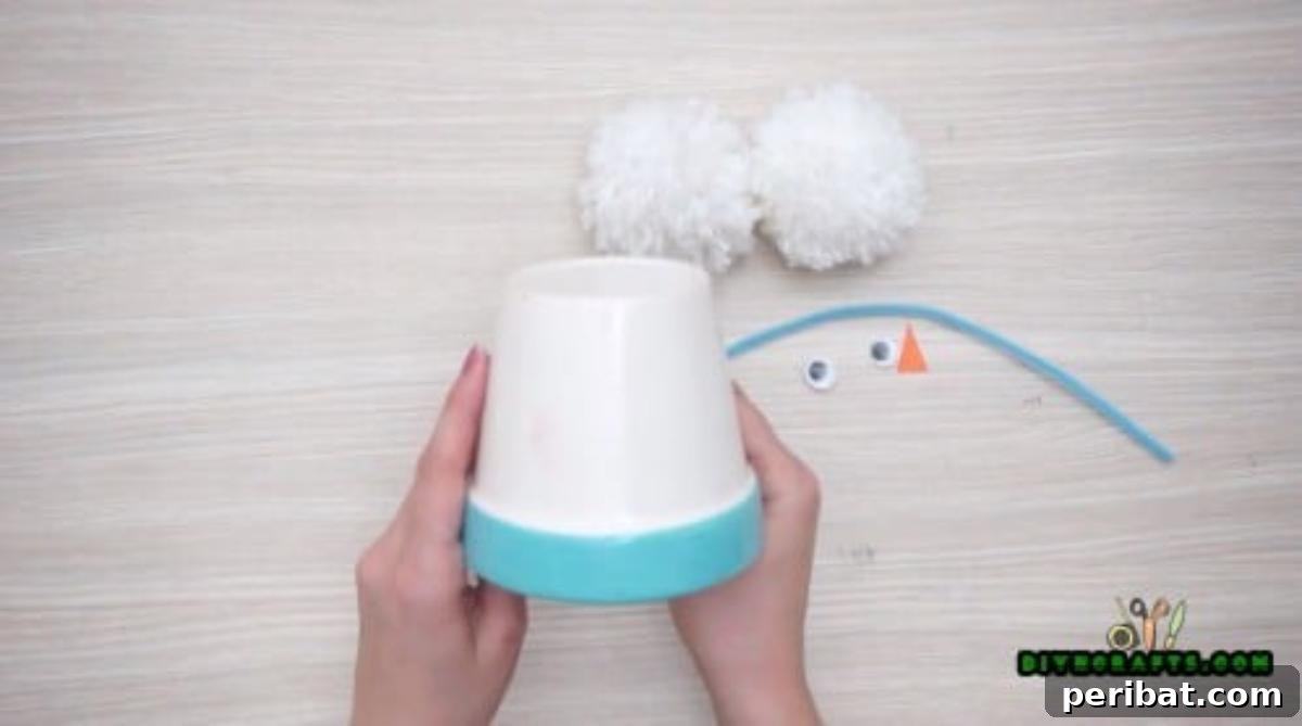 Minute-Made Snowmen: 5 Speedy & Creative Crafts 10 An inverted small white plastic cup, forming the body of an earmuff snowman craft