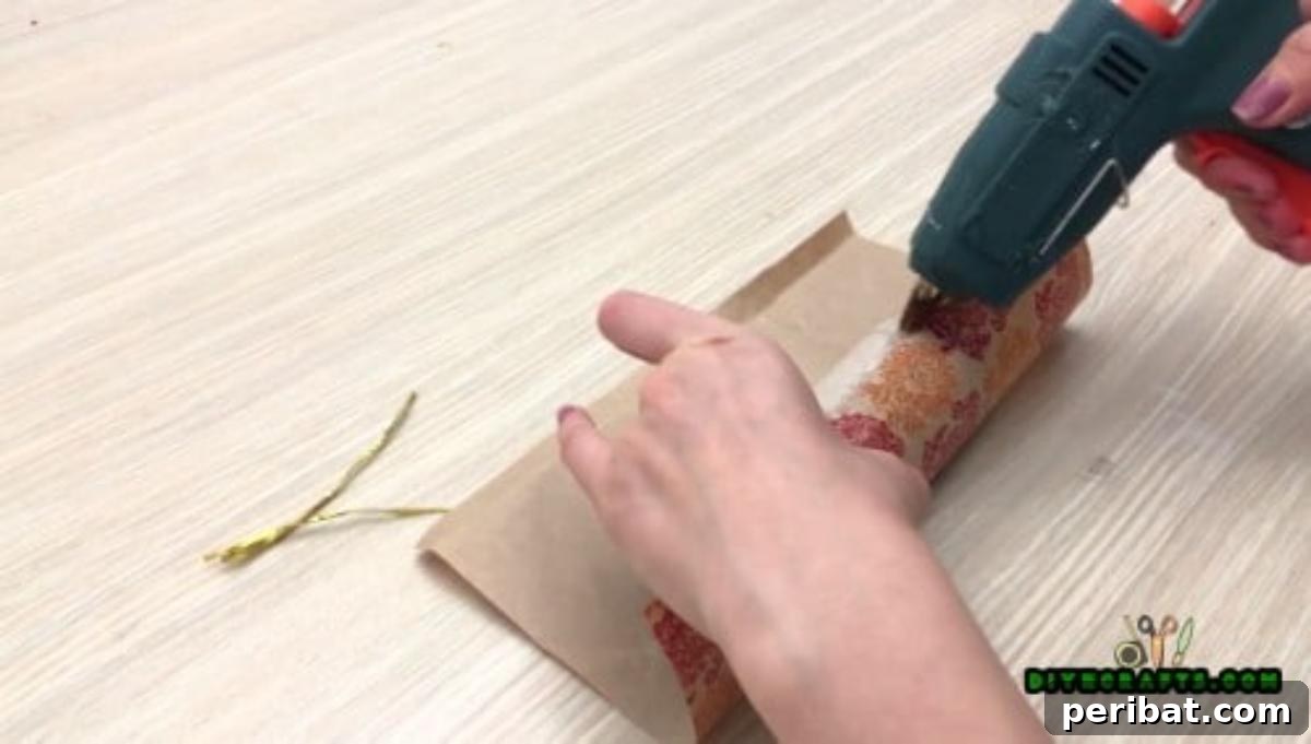 Upcycle Paper Rolls: 5 Easy Holiday Decoration Ideas 15 Christmas Cracker - Step 2: Gluing the decorative paper seam