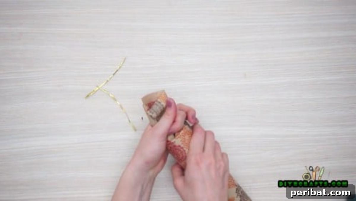 Upcycle Paper Rolls: 5 Easy Holiday Decoration Ideas 16 Christmas Cracker - Step 3: Pinching and tying one end of the cracker