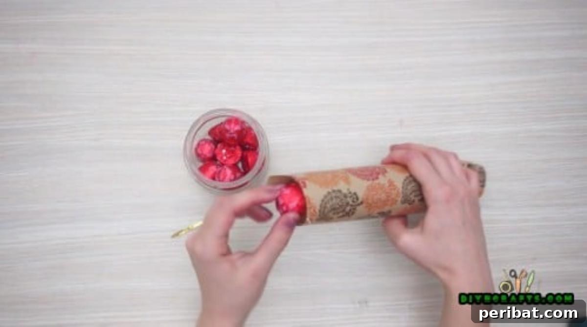 Upcycle Paper Rolls: 5 Easy Holiday Decoration Ideas 18 Christmas Cracker - Step 4: Filling the cracker with candies