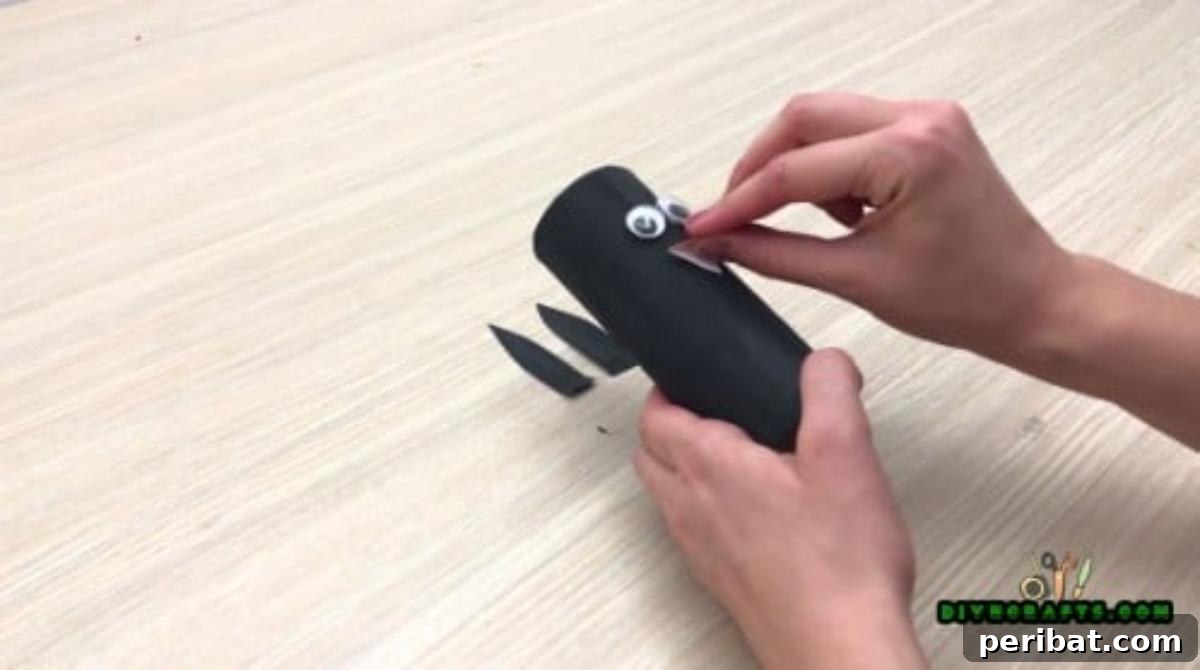 Upcycle Paper Rolls: 5 Easy Holiday Decoration Ideas 22 Cute Penguin - Step 3: Attaching an orange paper beak