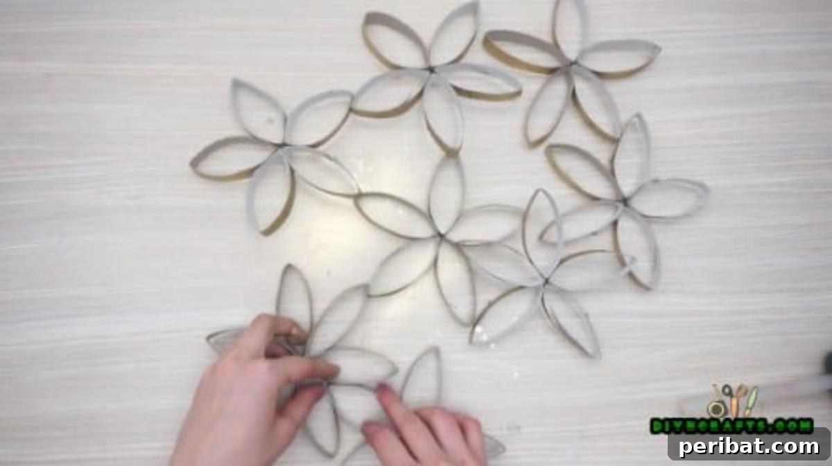 Upcycle Paper Rolls: 5 Easy Holiday Decoration Ideas 31 Flower Wreath - Step 5: Progress of gluing metallic flowers into a wreath shape