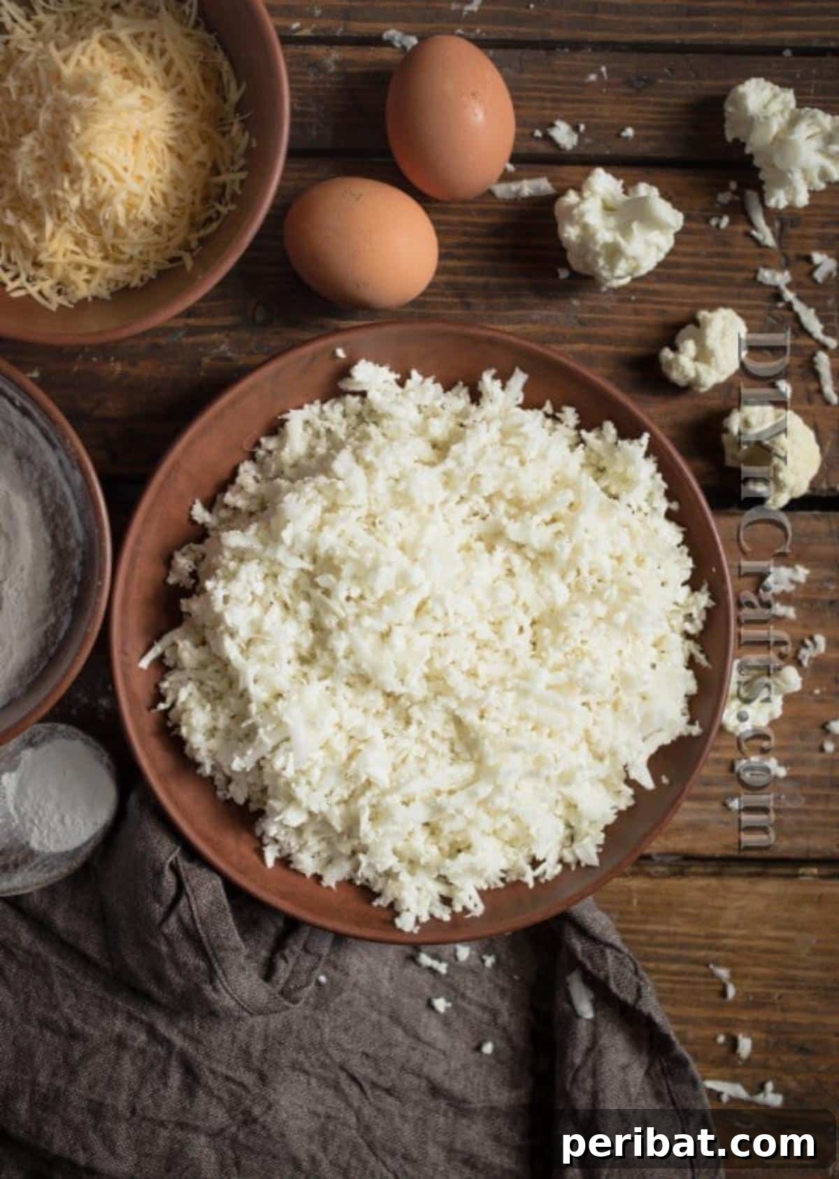 Cauliflower Fritters: The Guilt-Free Upgrade to a Beloved Classic 3 Close-up of freshly minced cauliflower, ready to be mixed into the fritter batter. Highlighting the texture.