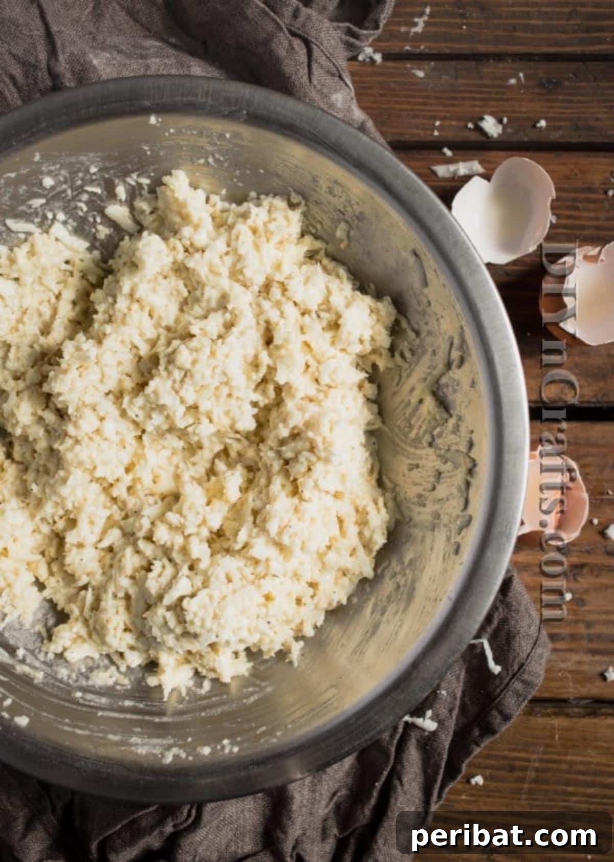 Cauliflower Fritters: The Guilt-Free Upgrade to a Beloved Classic 4 Cauliflower fritter batter in a bowl, showcasing the combined ingredients before frying. Focus on consistency.