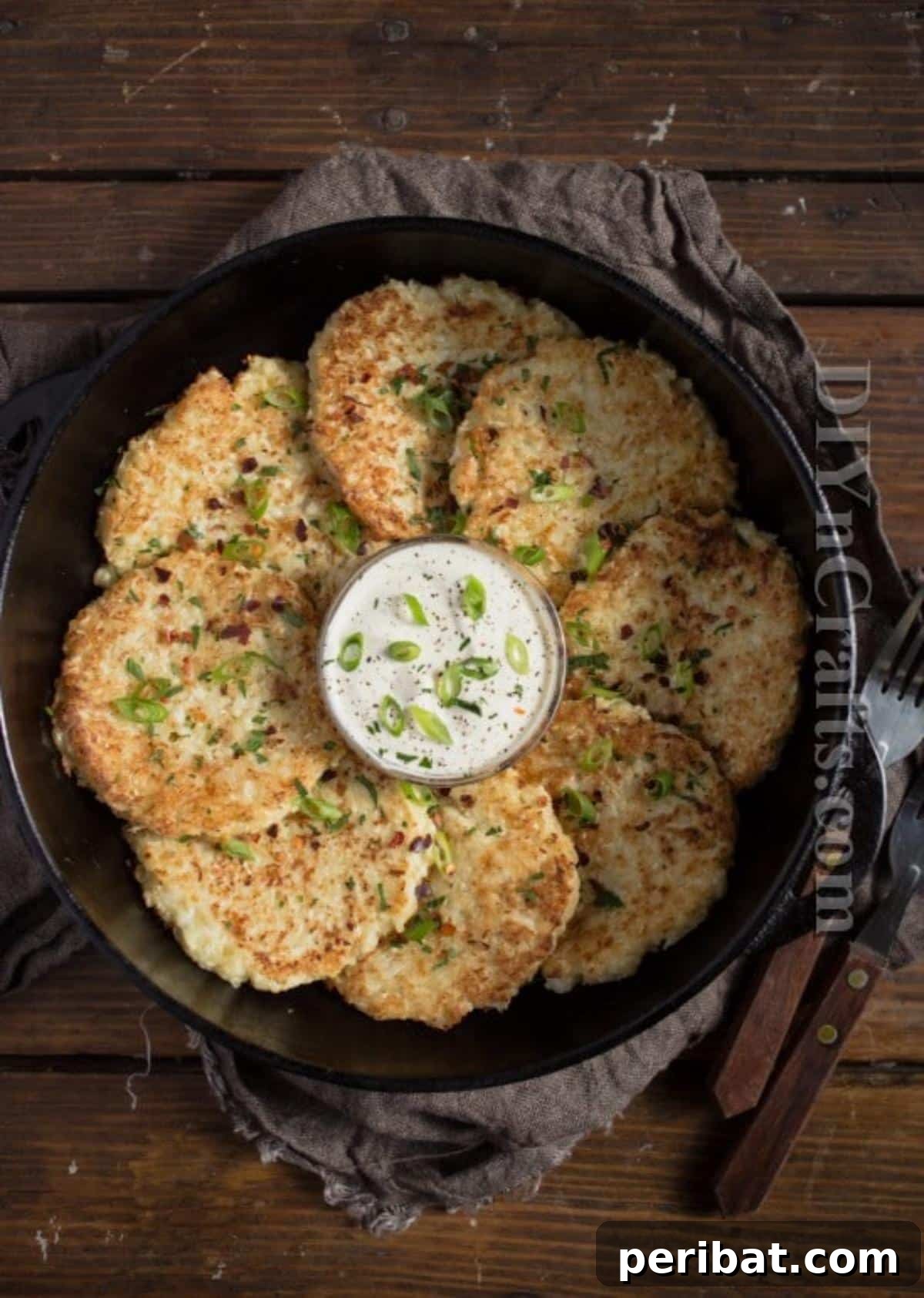 Cauliflower Fritters: The Guilt-Free Upgrade to a Beloved Classic 7 A stack of perfectly cooked golden cauliflower fritters on a plate, ready for serving. Highlighting the final product.