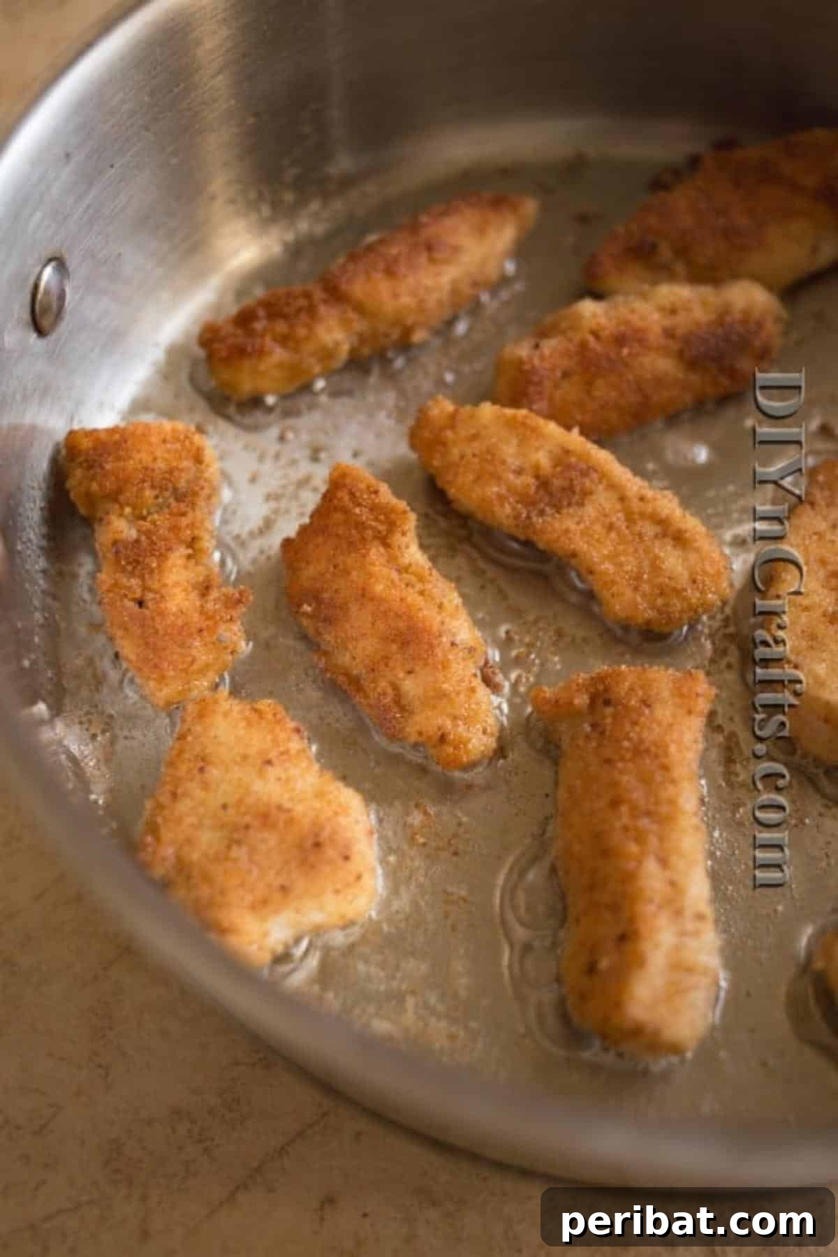 Browning chicken nuggets in oil for extra crispiness