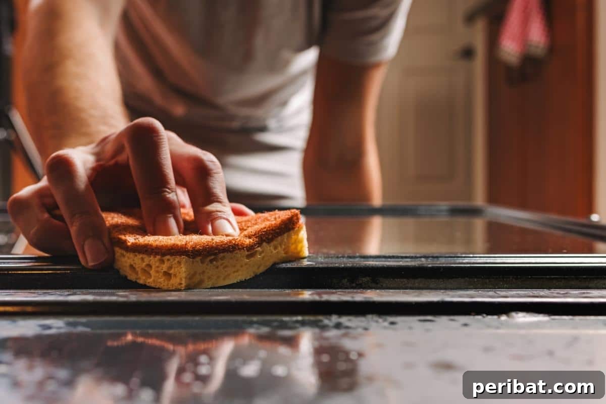 A person diligently scrubbing a stove top with a natural, homemade cleaning solution, showcasing effective kitchen cleaning.