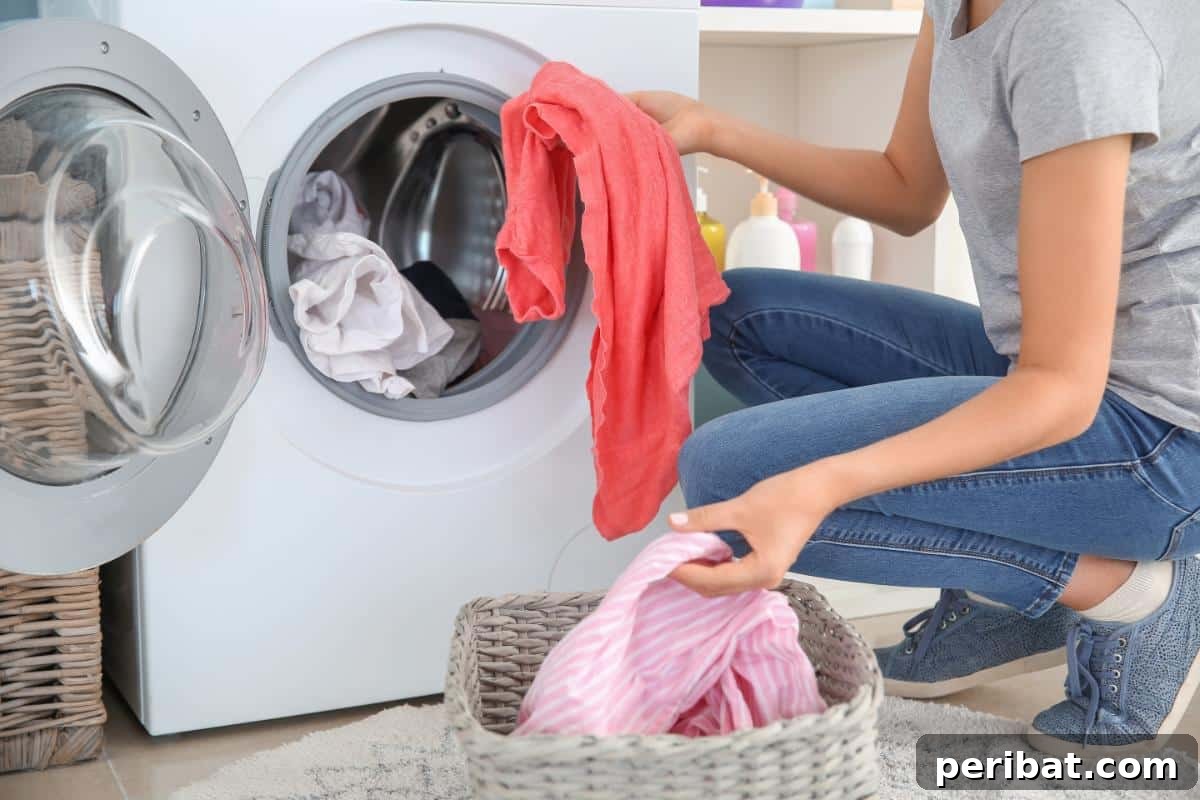 A woman's hands adding homemade laundry detergent to a washing machine, highlighting eco-friendly laundry practices.
